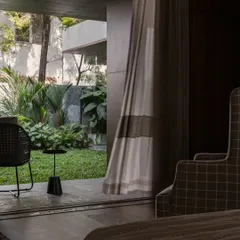 A view from a bedroom in the Pràna house, looking out onto the lush garden. We designed the home so that every room has a beautiful connection to the outdoors.