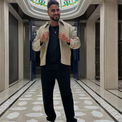 A full-length shot in a grand hotel corridor before a show. My personal style is modern and clean, ensuring I look the part for any upscale corporate event.