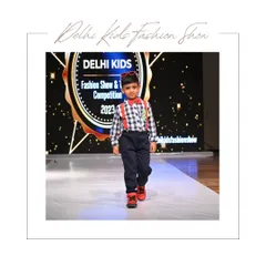 A classic, dapper look for the young gentleman. He walks the runway with focus and style in a checkered shirt, bright red suspenders, and a bow tie. This type of shot captures a timeless charm and is essential for a well-rounded children's portfolio.