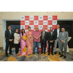 A group of industry leaders and our team pose in front of a branded backdrop for a hospitality forum. We are a chosen venue for key professional gatherings in the city.