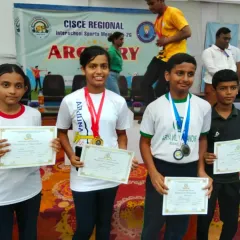 Our archers proudly displaying their medals and certificates. Each win is a team effort, reflecting the supportive community we've built.