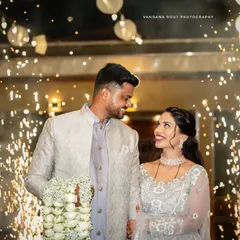 A close-up of the couple during their sparkler entrance, focusing on their loving gaze. Capturing these intimate interactions amidst a grand celebration is key to my couple photoshoot approach.