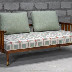 The Ela diwan, or daybed, is a minimal, handcrafted piece accentuated by a custom block-printed fabric and brass-tipped legs. With optional cushions, it can easily double up as a casual sofa.