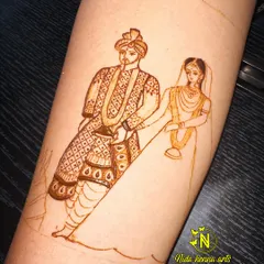 Step three: adding the intricate patterns and shading to the groom's attire. This layering technique is what creates depth and a rich, designer look in your mehandi.