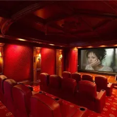 This all-red classic theater design creates a dramatic and immersive atmosphere. We used patterned acoustic wallpaper, elegant wall sconces, and tiered leather seating to build a space that is both visually stunning and sonically perfect.