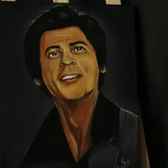 An angled view of the SRK painting, highlighting the lighting and shadows on his face.