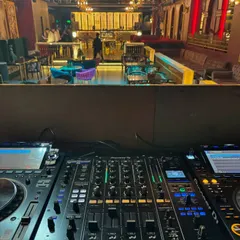 This is the command center. A view from the DJ booth we equipped with a Pioneer CDJ 3000 and DJM A9 mixer, looking out over the club. We provide DJs with the industry-standard equipment they need to perform at their best.