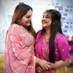 A heartwarming candid moment of laughter between the bride and a friend or sister during the Haldi function. These are the moments we love to preserve.