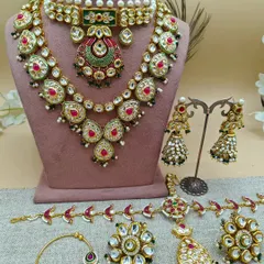 This is what a full bridal rental set looks like. It includes a choker, a long necklace (rani haar), earrings, a nath (nose ring), haath phool (hand harness), and a maang tikka. I ensure every piece is coordinated to give you a complete, polished look.