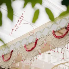 I believe in the quiet poetry of handcrafted details. For this South Indian wedding, we designed these delicate valances with handwoven petal garlands in soft pastel tones, bringing a modern, serene elegance to a cherished tradition.