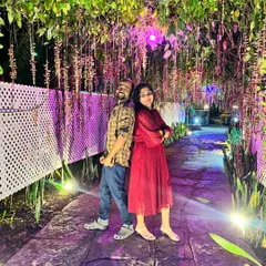 Another romantic shot of a couple at our Ramanagara resort, enjoying the magical ambiance of the illuminated pathway.