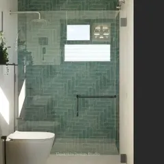 A closer look at the herringbone pattern and aqua subway tiles in this shower design. The frameless glass partition keeps the space feeling open, while the dark fixtures provide a modern contrast. It's a simple mood check that delivers a big impact.