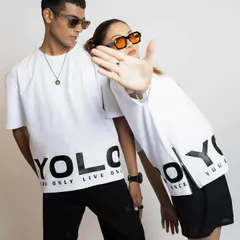 This image showcases the brand's "YOLO" graphic tee with cool, modern accessories. The styling with tinted sunglasses adds to the edgy, youthful vibe of the campaign.