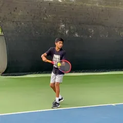 Yashas in action, preparing to serve during a match. This focus and technique are honed through countless hours of dedicated practice at our academy.