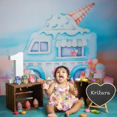 A big, happy shout of joy. Cake smash sessions are all about letting go and having fun, and this little one is definitely enjoying her special day.
