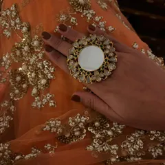 A close-up of my accessories for the palace wedding. A statement mirror-work ring adds a contemporary touch to the traditional saree.