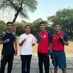 Our coach with a group of young, determined trainees. We believe in building a strong foundation and a sense of teamwork from day one.
