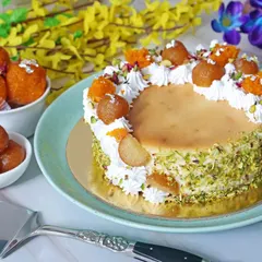 A beautifully styled shot of a Gulab Jamun fusion cake, combining traditional Indian sweets with modern baking. This type of creative food photography is great for bakeries and sweet shops wanting to highlight their unique menu items.