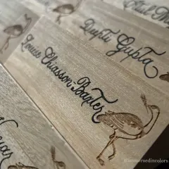 Another angle of the custom wooden nameplates, showing the consistency of the calligraphy across different names. Each piece was personalized for event guests.