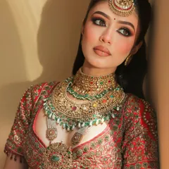 The definition of a Royal Indian Bride. This close up shot showcases the satin matte skin, flushed cheeks, and bold kohl eyes that I created to complement her magnificent red lehenga.