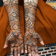 A stunning full coverage design for an engagement bride. The mix of floral and geometric patterns creates a rich and celebratory look.