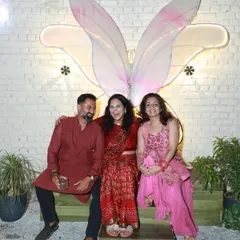 Guests posing in front of our butterfly wing installation. I added this piece to be a fun and beautiful backdrop for your photos and memories.