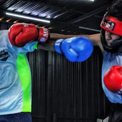 Two fighters exchanging punches during a technical spar. The focus here is on timing and distance, not just power. Notice the extension on the straight right.