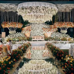 For a truly regal affair, I design spaces that exude luxury and grandeur. This stunning reception at the Taj West End features a magnificent floral stage and a mirrored aisle that reflects the entire spectacle, creating an atmosphere of pure opulence for you and your guests.