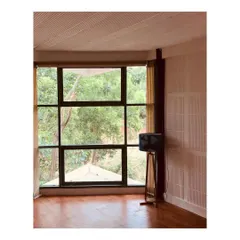 In this farmhouse retreat, a large window frames the lush greenery outside, turning nature into living art. My focus here was on biophilic design, creating a seamless connection between the interior and the exterior for a truly peaceful weekend home.