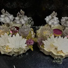 A touch of silver to make Diwali celebrations sparkle. These matching hampers feature silver-plated diyas and dry fruit holders, making for a truly luxurious festive gift.
