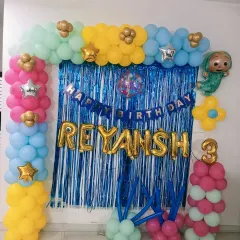 A colorful Cocomelon-themed decoration for Reyansh's 3rd birthday at his home in Noida. A balloon frame with a shimmer curtain is a great way to create a party corner in your living room.