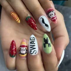 A quirky and eclectic mix of hand-painted designs on almond nails. This set includes a strawberry, a Minecraft Creeper, cartoon characters, and the word 'SWAG', showing our ability to create any custom design you can imagine.