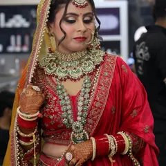 A detailed shot of the final bridal makeup. You can see the precision in the eye makeup, the seamless blending of the contour, and how the jewelry is perfectly complemented by the makeup tones.