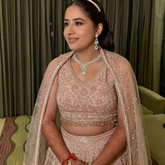 A smiling shot of Niyamat. Her makeup is elegant and sophisticated, perfect for a cocktail party.