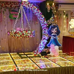 Here is a princess-themed naming ceremony stage we designed. It features a beautiful floral cradle, doll cutouts, and an illuminated crescent moon arch, all set on our signature LED floor.