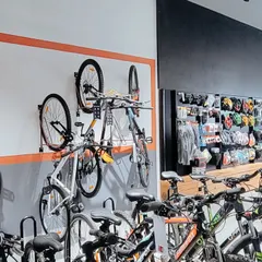 Wall-mounted racks are a space-efficient solution for displaying bicycles. This setup keeps the floor clear and creates an organized, grid-like visual that is easy for customers to browse.