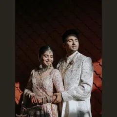 We are chasers of that perfect light. Here, the golden hour sun casts dramatic shadows, highlighting the couple's serene connection and the intricate details of their wedding attire in a shot that feels like a page from a magazine.