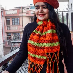Here I am modeling a handmade crochet beret and a matching striped scarf. This shows how my winter wear is not only warm but also stylish, perfect for adding a pop of color to your cold-weather outfits.
