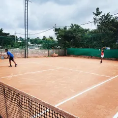 Two players compete in a doubles match, showcasing teamwork and court positioning.