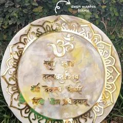 A finished resin mantra frame featuring the Gayatri Mantra. The sacred text is surrounded by a beautiful lotus-inspired border and finished with gold details.