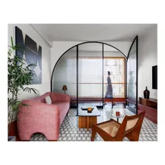 In this lounge, I used a bold color palette and a custom arched glass screen to define the space while maintaining a sense of openness. The design balances modern art with classic materials for a home that feels both exciting and comfortable.