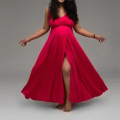 Unleash your inner queen with a bold and dynamic pose. This vibrant red flowing gown is part of my extensive collection, perfect for creating powerful and fashionable maternity portraits.