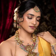 A moment of quiet elegance, showcasing a unique antique necklace with Kempu and pearl accents. This piece is inspired by temple art and adds a touch of heritage to a modern look.