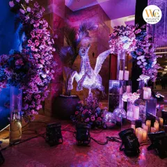 A close-up of the decor details, including a sparkling pegasus statue, mirrored pedestals, and lush purple floral arrangements that enhanced the celestial theme.