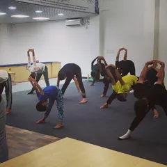 Yoga poses like the forward bend help release tension in the back and shoulders, areas that bear a lot of stress during shooting practice.