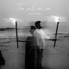 A creative double-exposure image in black and white, showing a couple with torches on a beach. The text "Two souls, one now" adds a romantic, artistic touch to this unique save-the-date photo idea.