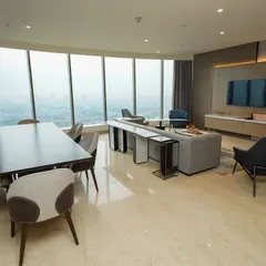 A different perspective of the open-plan living and dining area, showing the relationship between the seating arrangement, dining table, and the expansive view.