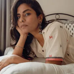 An intimate indoor portrait for a clothing brand, focusing on the model's direct gaze. This demonstrates how I create a personal connection and moody atmosphere even in a commercial lifestyle shoot.