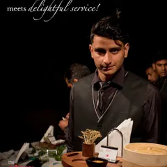 At your service! Our professional and well-dressed server is ready to offer guests delicious appetizers, ensuring a delightful and seamless experience.
