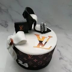 Another take on our popular Louis Vuitton theme, this cake is a fashionista's dream. It's adorned with an edible high-heeled shoe and a chic bow.